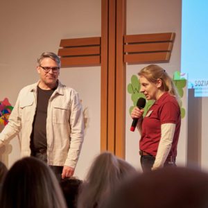 Pastor Thilo Kierner und Geschäftsführung Sozialwerk Jana Schwolow machen Ansagen im Gottesdienst